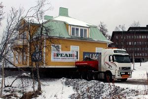 fotografi på hus som flyttas på långtradare i vintertid i Kiruna